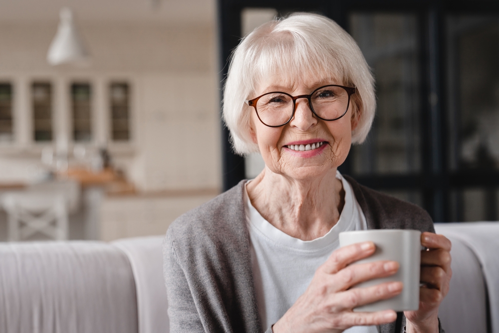 Woman holding coffee in senior living in medford, Oregon.